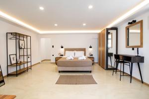 a bedroom with a bed and a mirror and a piano at Spitaki Pool House & Spitaki Jacuzzi Deluxe Suite in Corfu +58 photos