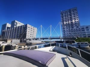a boat in the water with a bridge in the background at Eco Yacht Charters in Almere