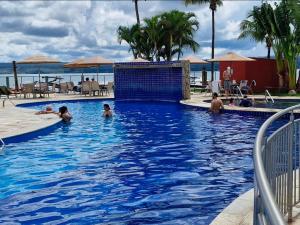 a group of people playing in a swimming pool at Premier Residence in Brasília +25 photos