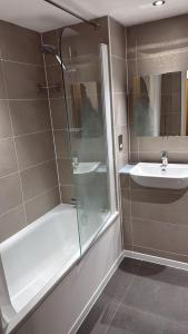 a bathroom with a shower and a sink at Malijeed Services limited in London
