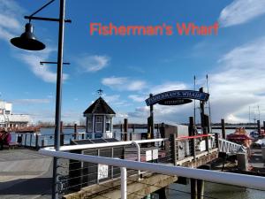 a pier with a sign that reads fishermans wharf at Bed Plus One in House in Richmond
