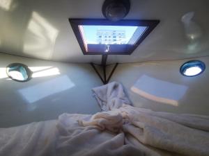 a room with a bed with a television on the ceiling at Eco Yacht Charters in Almere