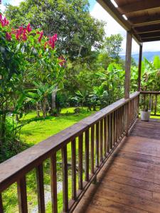 a wooden porch with a view of a garden at The Temple I, Mindo in Mindo