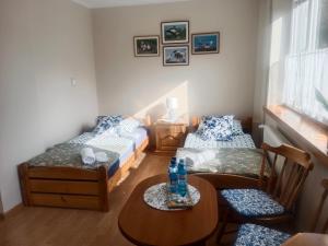 a room with two beds and a table and chairs at ZŁOTY BUK in Jagniątków