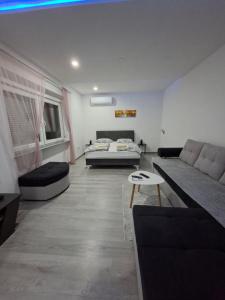 a living room with a couch and a table at Apartman Edwin Jajce in Jajce