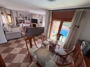 a living room with a glass table and chairs at Chalet con Piscina Aguadulce in Aguadulce