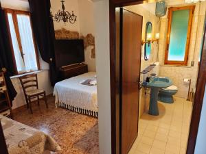 a bathroom with a bedroom with a bed and a sink at Nostra Torre in Filettole +40 photos
