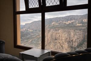 a room with a window with a view of a mountain at Alsharafh room 2 in Al ‘Aqar