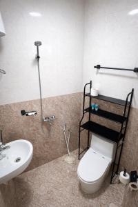 a bathroom with a toilet and a sink at Alsharafh room 2 in Al ‘Aqar