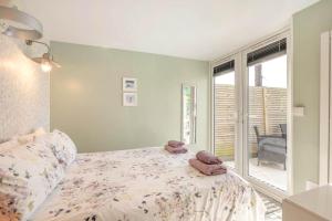 a bedroom with a bed with two stuffed animals on it at 1 Bed in Beccles oc-65080 in Beccles