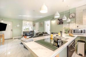 a kitchen with a counter top and a living room at 1 Bed in Beccles oc-65080 in Beccles