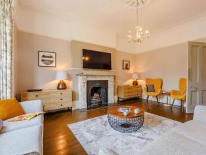 a living room with a couch and a fireplace at 5 Bed in Sandown oc-87008 in Sandown