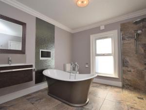 a large bathroom with a tub and a shower at 5 Bed in Sandown oc-87008 in Sandown +29 photos