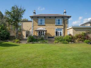 a large brick house with a grass yard at 5 Bed in Sandown oc-87008 in Sandown