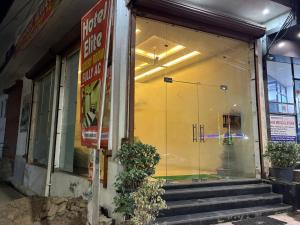a store front with a large glass window and stairs at Hotel elite in Palwal