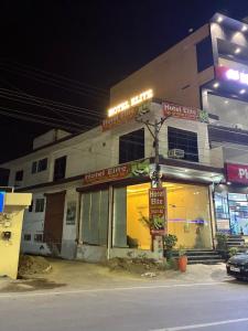 a fast food restaurant on a street at night at Hotel elite in Palwal