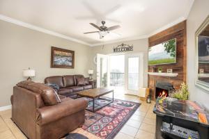 a living room with a couch and a fireplace at Mountain View Condo 1306 in Pigeon Forge