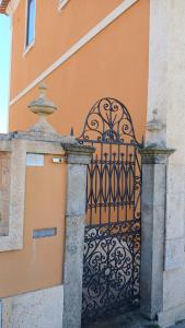 an entrance to a building with a black gate at Casa de St António in Murtosa