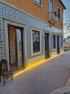 a building with lights on the outside of it at Casa de St António in Murtosa
