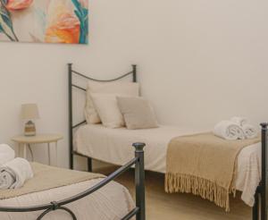 a bedroom with two beds with towels on them at La Primavera in Anacapri