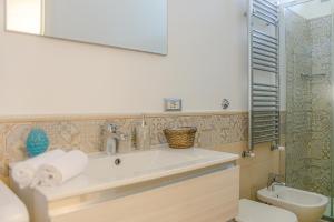 a bathroom with a sink and a toilet and a mirror at La Primavera in Anacapri +26 photos