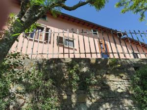 a house on top of a wall with a fence at Villa Paradiso Julia in Dicomano