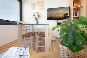 a living room with a glass table and stools at Strandhaferweg 7 Beach Apartment Fehmarn in Burgtiefe auf Fehmarn 