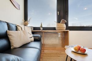 a living room with a couch and a table at Strandhaferweg 7 Beach Apartment Fehmarn in Burgtiefe auf Fehmarn 