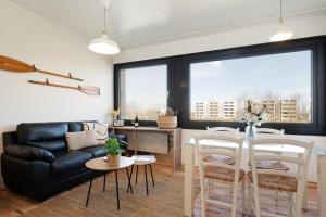 a living room with a couch and a table at Strandhaferweg 7 Beach Apartment Fehmarn in Burgtiefe auf Fehmarn 