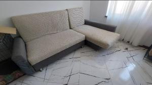 a couch sitting on the floor in a room at DOR ApartHotel in Chişinău