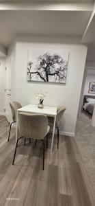 a dining room with a white table and chairs at Cobblebrook Executive Suites in Airdrie