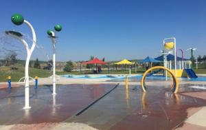 a water park with a playground with a water slide at Cobblebrook Executive Suites in Airdrie
