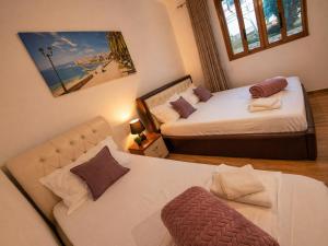 a bedroom with two beds and a couch in it at Amar Seaside in Ksamil +39 photos