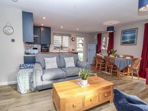 a living room with a couch and a table at Mayfly Lodge in Bodmin