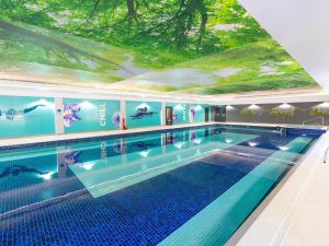a large swimming pool with a large ceiling at Mayfly Lodge in Bodmin