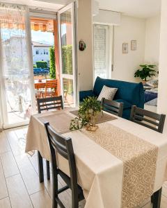 a dining room with a table and chairs and a couch at Ninfa del lago - PRIVATE GARAGE in Colico