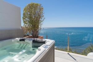 a bath tub with a view of the ocean at Maryvilla Inspiración y Vacaciones - Villa Mascarat in Calpe