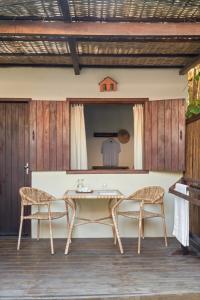 a table and two chairs on a patio at Pousada Nativa in Caraíva
