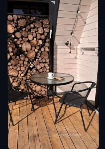 a table and two chairs and a coffee cup on a patio at A-frame У Евелінки in Vorokhta +16 photos