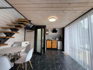 a kitchen and dining room with a table and chairs at A-frame У Евелінки in Vorokhta