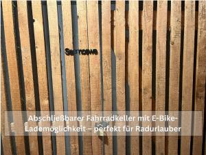 a close up of a fence with a sign on it at Ruhige Ferienwohnung Seemöwe mit Balkon - ideal für Paare & Radurlauber in Radolfzell am Bodensee