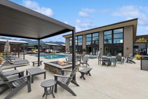a patio with tables and chairs and a fire pit at Quarry B10 in Whitefish