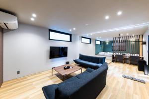 a living room with two blue couches and a table at 2F, 3F - Vacation STAY 20122v in Sumiyoshi