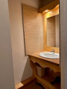 a bathroom with a sink and a mirror at Duplex « les 7 Marmottes », 306 in Chamrousse +7 photos