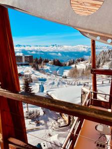 a view from the balcony of a ski resort in the snow at Duplex « les 7 Marmottes », 306 in Chamrousse