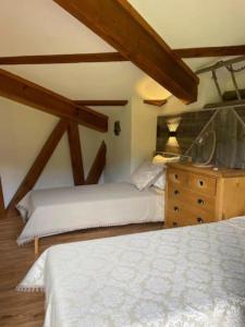 a bedroom with two beds and a wooden dresser at Duplex « les 7 Marmottes », 306 in Chamrousse