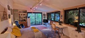 a room with a bed and a table and chairs at Au fil de l'eau in Chambonas