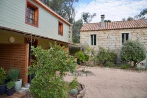 a house with a yard next to a building at Chambres d'Hôtes Barraconu in Porto-Vecchio