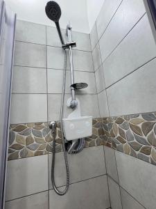 a shower with a shower head in a bathroom at DomusVenere in Santa Croce Camerina
