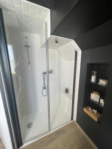 a bathroom with a shower with a glass door at Le Clos d Emilie in Saint-Marcel +59 photos